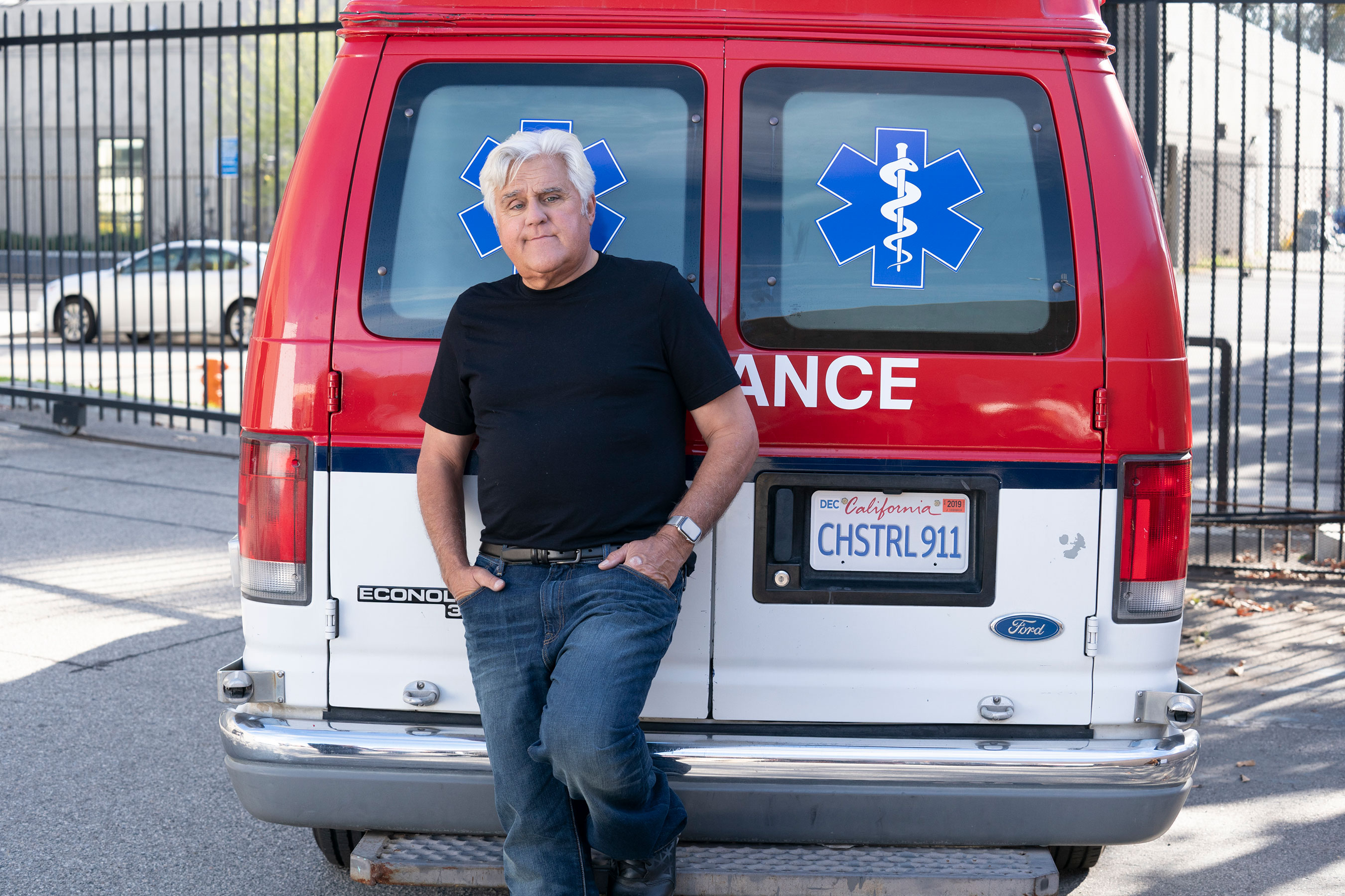 Jay Leno poses by an ambulance