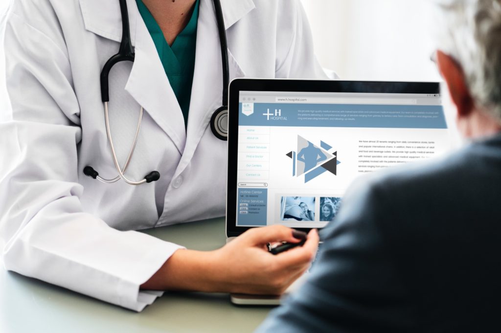 Doctor showing patient medical information on a tablet computer